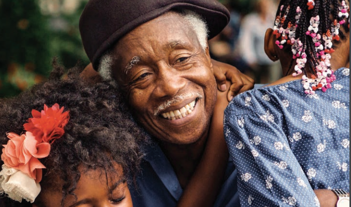 man hugging daughters