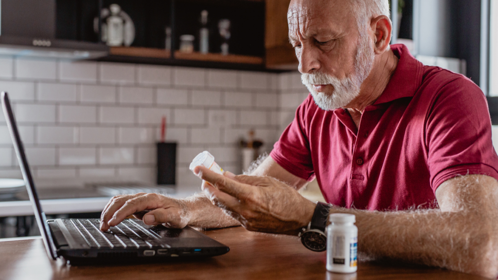 Person looking at a prescription bottle at a computer