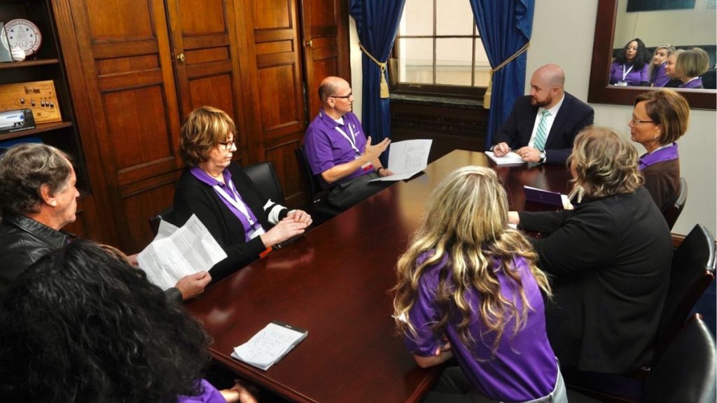 Group of people sitting around a meeting table having a discussion 